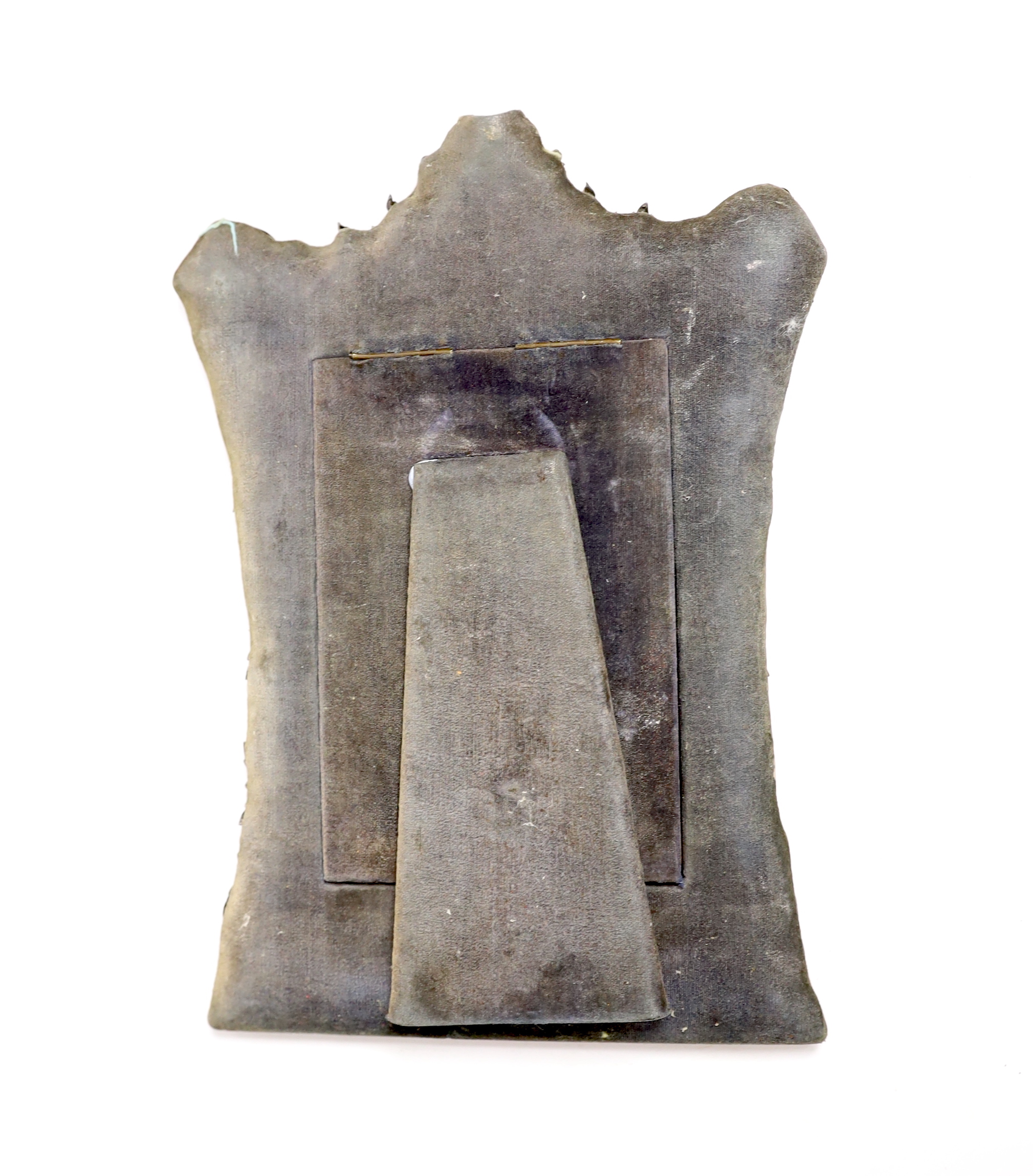 A Burmese white metal mounted shaped rectangular photograph frame, decorated with elephants and figures amongst scrolls, 29.2cm.